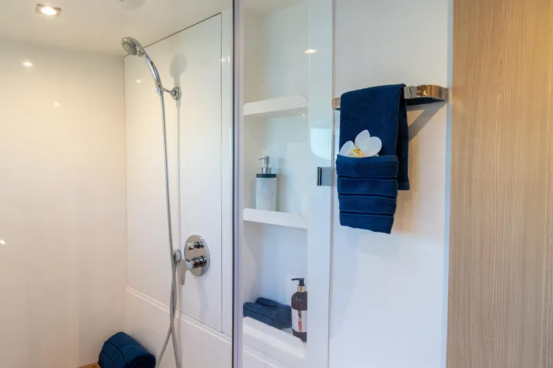 Superlux Yacht Photos Pics Modern bathroom in 2023 Aquila 42 Yacht with sleek shower and elegant shelving.