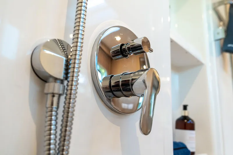 Superlux Yacht Photos Pics Shiny chrome shower control in 2023 Aquila 42 Yacht bathroom.