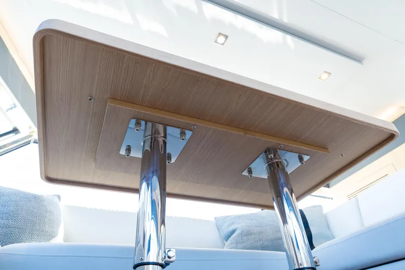 Superlux Yacht Photos Pics Underneath view of a wooden table on a 2023 Aquila 42 Yacht.