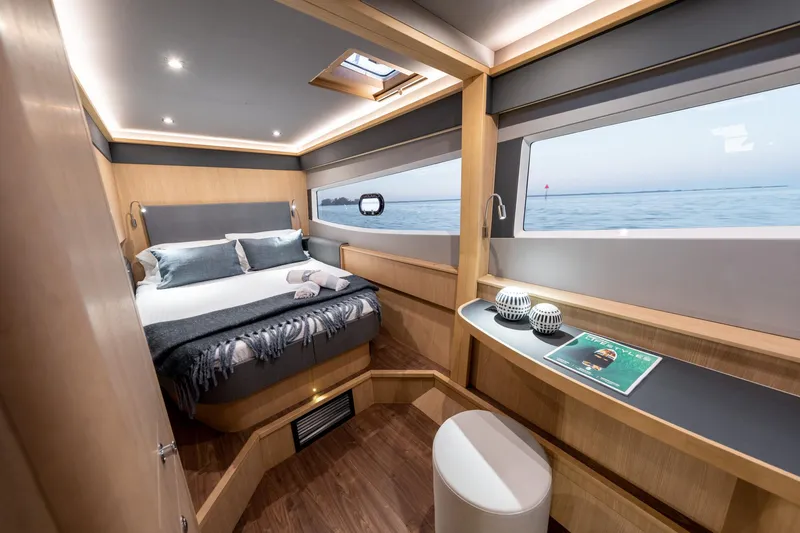 Superlux Yacht Photos Pics Luxurious cabin interior of 2023 Aquila 42 Yacht with ocean view windows.