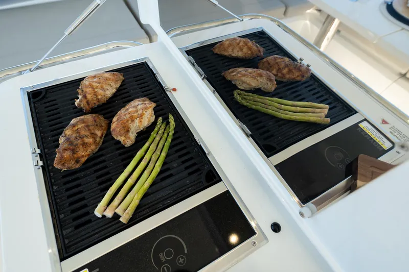 Superlux Yacht Photos Pics Grilled chicken and asparagus on Aquila 42 Yacht's outdoor grill, 2023 model.