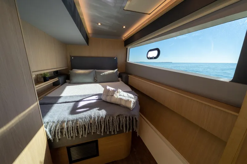Superlux Yacht Photos Pics Luxurious bedroom interior of 2023 Aquila 42 Yacht with ocean view.