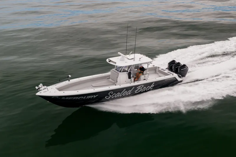  Yacht Photos Pics 2016 Contender 39 ST boat speeding on water with triple Mercury engines.