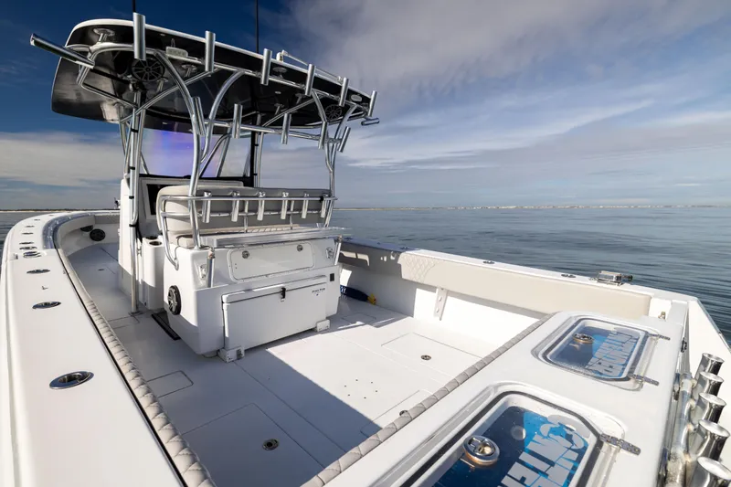  Yacht Photos Pics 2016 Contender 39 ST boat on calm water, featuring spacious deck and modern design.