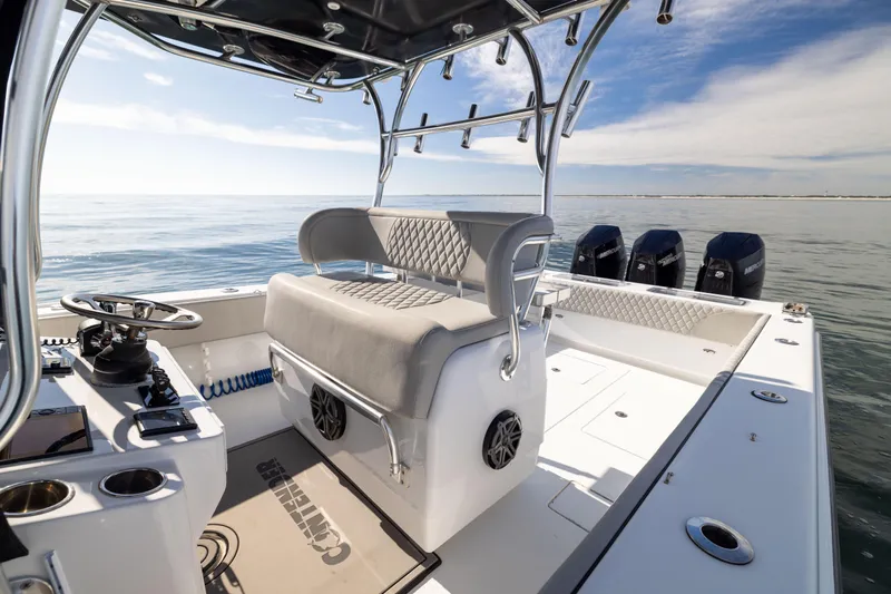  Yacht Photos Pics 2016 Contender 39 ST boat interior with helm, seating, and multiple outboard motors on calm water.
