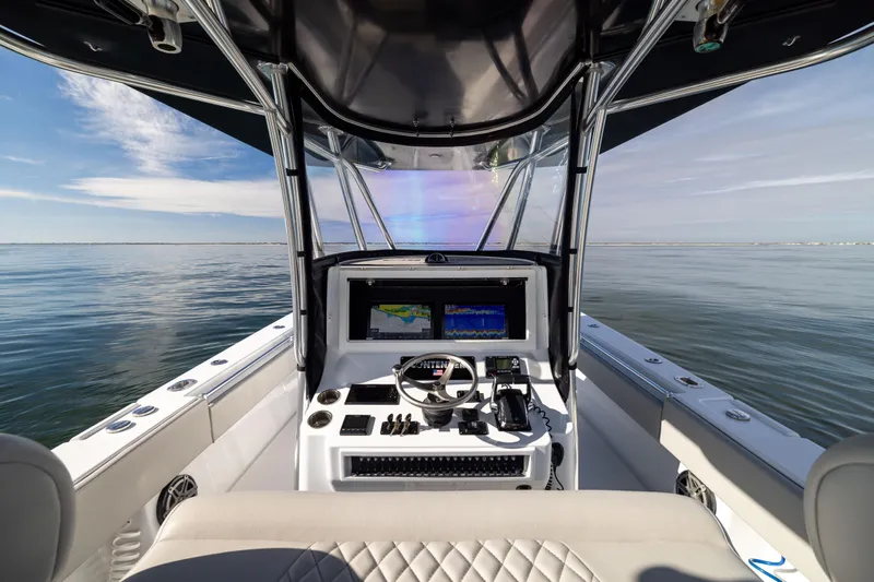  Yacht Photos Pics 2016 Contender 39 ST boat cockpit with navigation system on calm water.