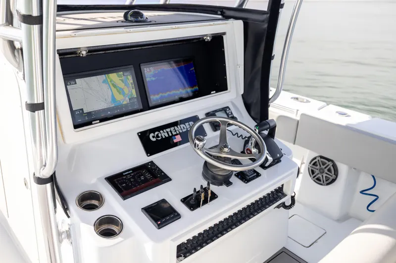 Yacht Photos Pics Helm of 2016 Contender 39 ST boat with navigation screens and steering wheel.