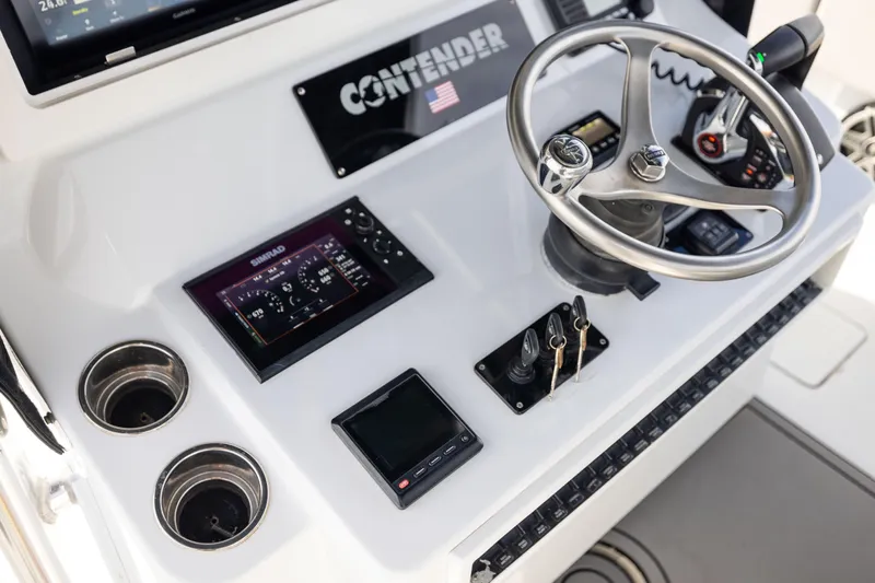  Yacht Photos Pics 2016 Contender 39 ST boat dashboard with steering wheel and electronic controls.