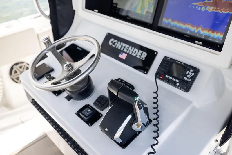  Yacht Photos Pics 2016 Contender 39 ST boat dashboard with steering wheel and navigation equipment.