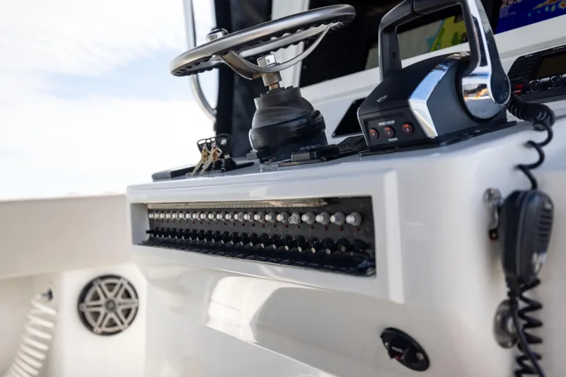  Yacht Photos Pics 2016 Contender 39 ST boat dashboard with controls and steering wheel.