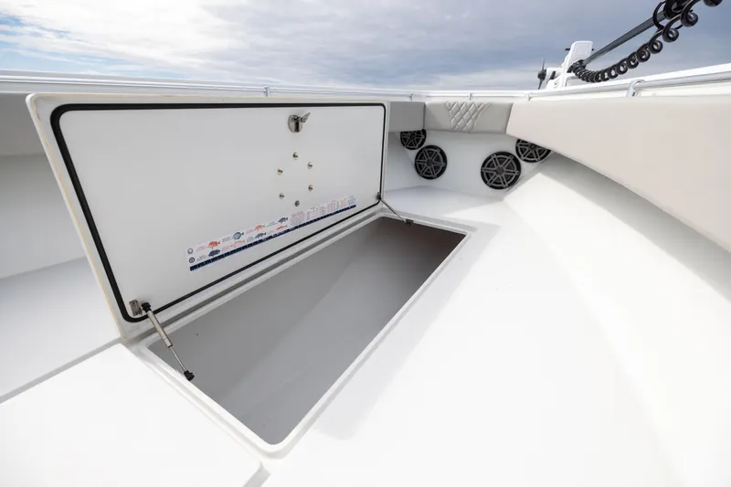  Yacht Photos Pics Open storage compartment on 2016 Contender 39 ST boat, featuring speakers and cushioned seating.