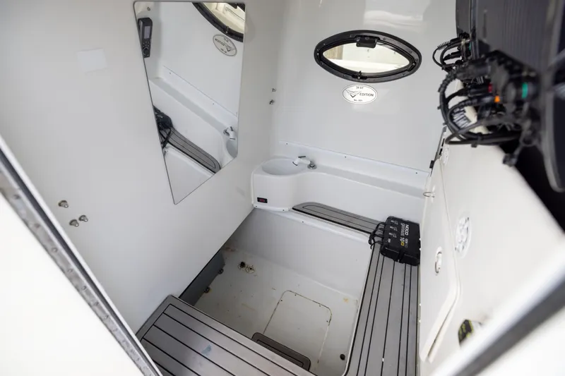  Yacht Photos Pics Interior of 2016 Contender 39 ST boat, featuring a compact cabin with seating and equipment.