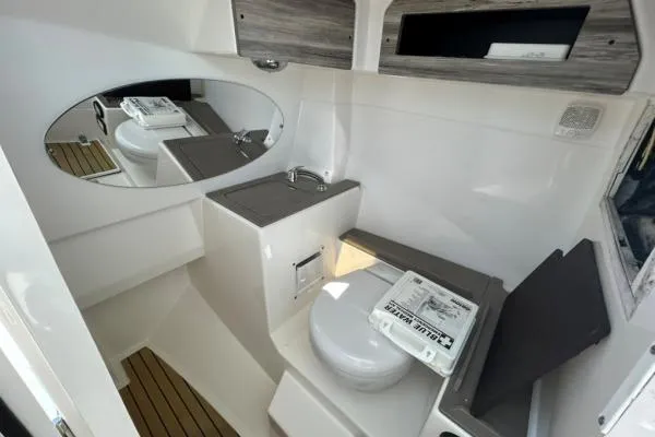 Little Mermaid Yacht Photos Pics 2019 Edgewater 262 CX boat interior with toilet, sink, and mirror.