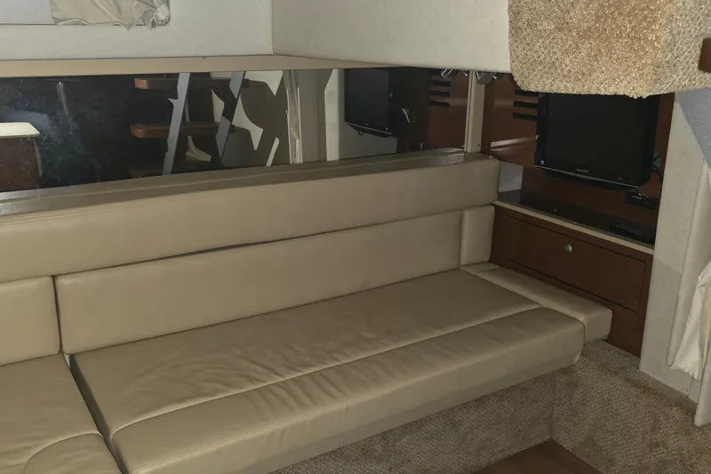 Lucky 13 Yacht Photos Pics Interior of 2009 Sea Ray Sundancer 350 with beige seating and TV.