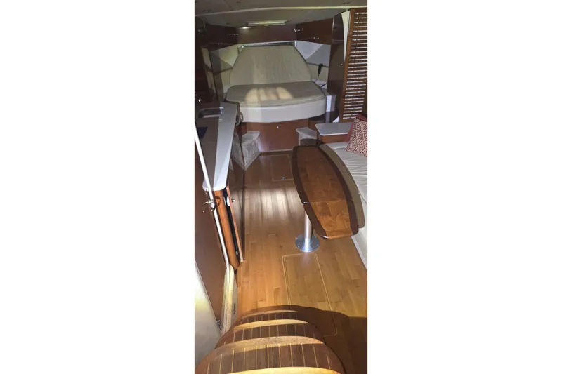 Lucky 13 Yacht Photos Pics Interior of 2009 Sea Ray Sundancer 350 yacht with wooden flooring and cozy seating area.