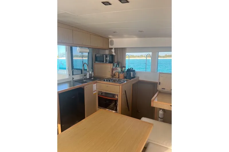 Cecil Yacht Photos Pics Interior of 2014 Lagoon 39 catamaran kitchen with ocean view through windows.