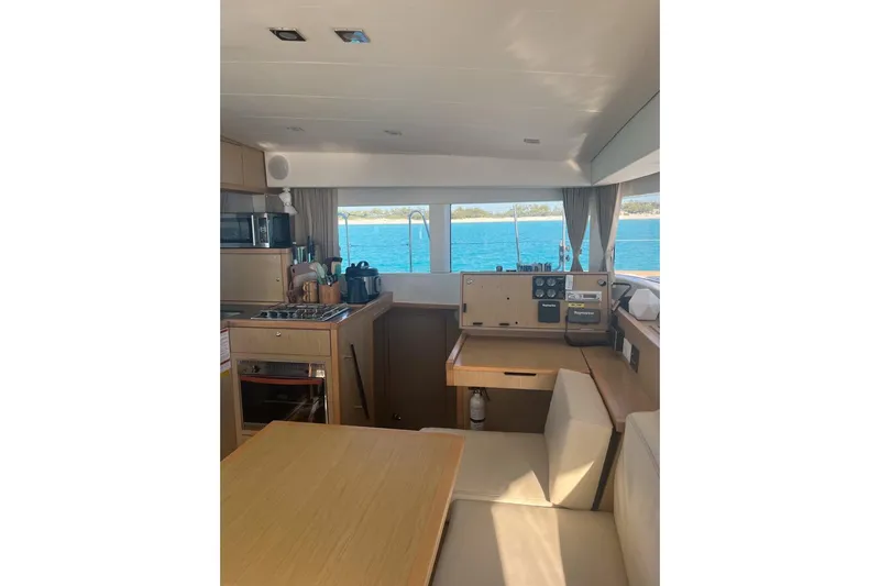 Cecil Yacht Photos Pics Interior of 2014 Lagoon 39 catamaran with kitchen and navigation area, overlooking the sea.