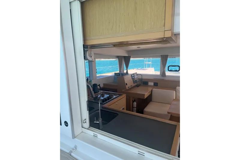 Cecil Yacht Photos Pics Interior view of 2014 Lagoon 39 catamaran, featuring kitchen and seating area with ocean backdrop.