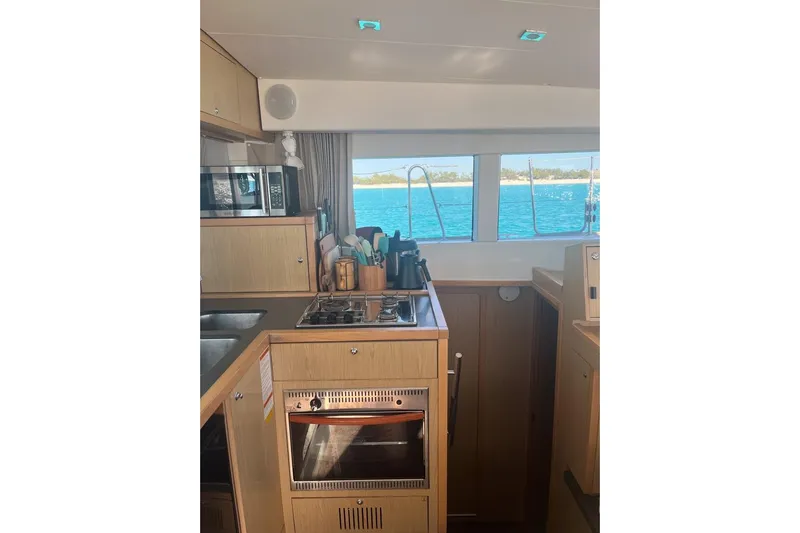 Cecil Yacht Photos Pics Interior of 2014 Lagoon 39 catamaran kitchen with ocean view through windows.