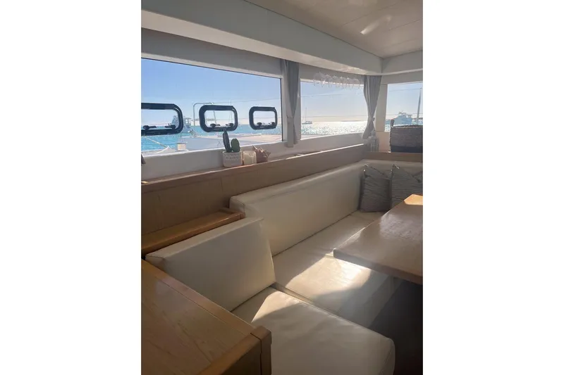 Cecil Yacht Photos Pics Interior of 2014 Lagoon 39 catamaran with cozy seating and ocean view through windows.