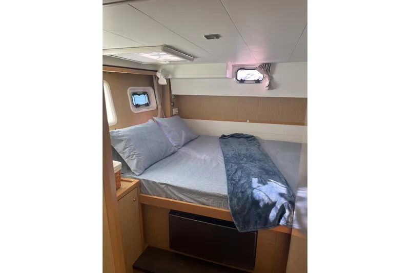 Cecil Yacht Photos Pics Cozy cabin interior of 2014 Lagoon 39 catamaran with bed and porthole windows.
