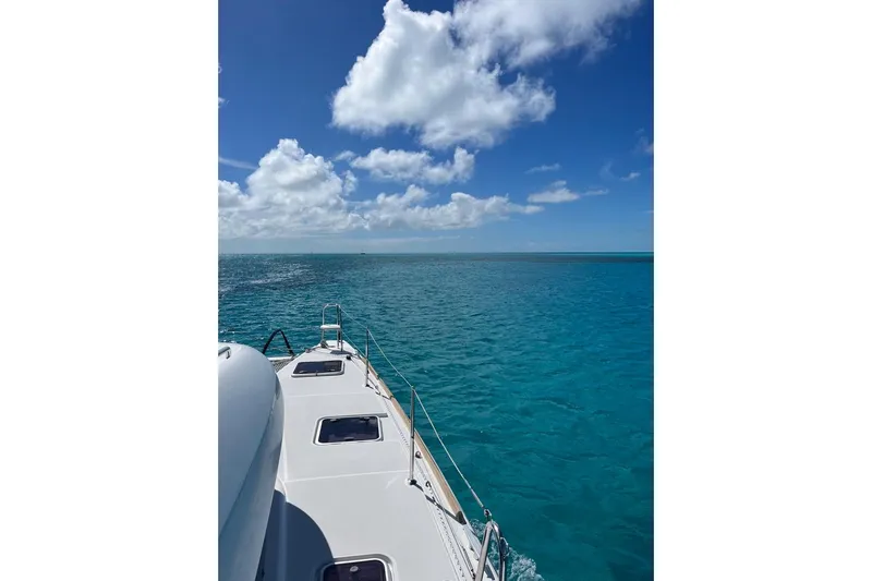 Cecil Yacht Photos Pics Lagoon 39 catamaran sailing on clear blue ocean under a bright sky, 2014 model.