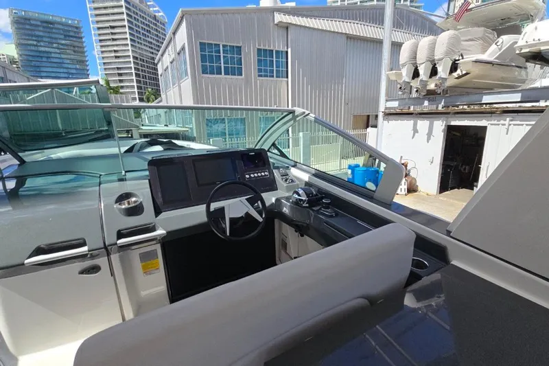  Yacht Photos Pics 2022 Aviara AV32 OB boat cockpit with modern controls, docked near urban buildings.