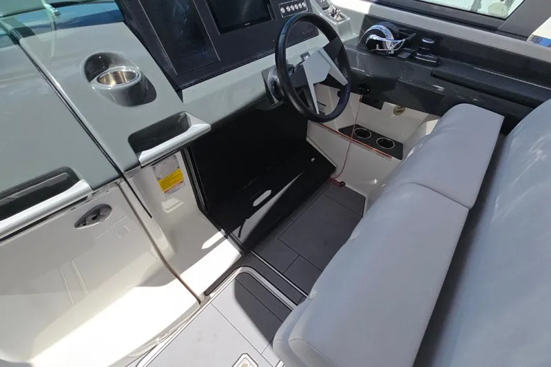  Yacht Photos Pics 2022 Aviara AV32 OB boat interior with steering wheel and seating area.