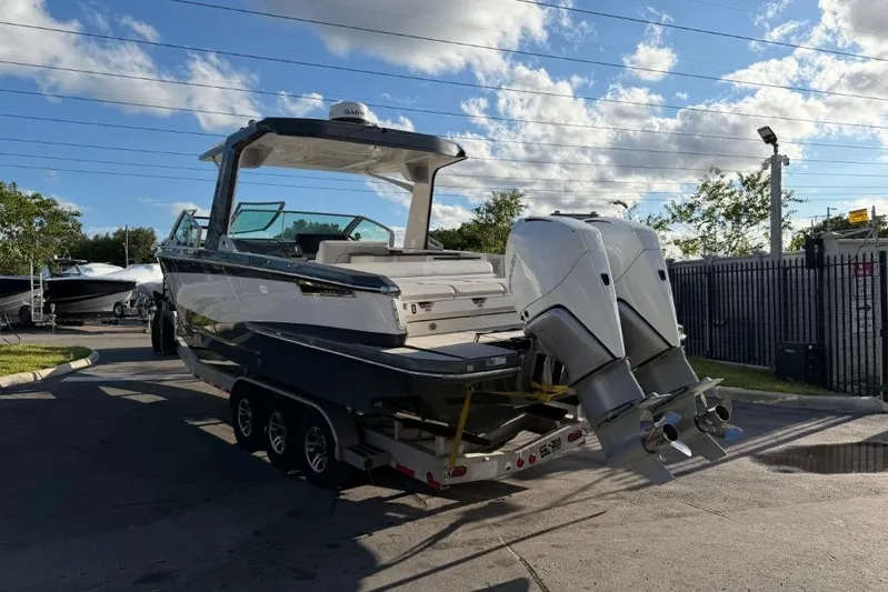  Yacht Photos Pics 2022 Aviara AV32 OB boat on trailer, dual outboard engines, sunny day.