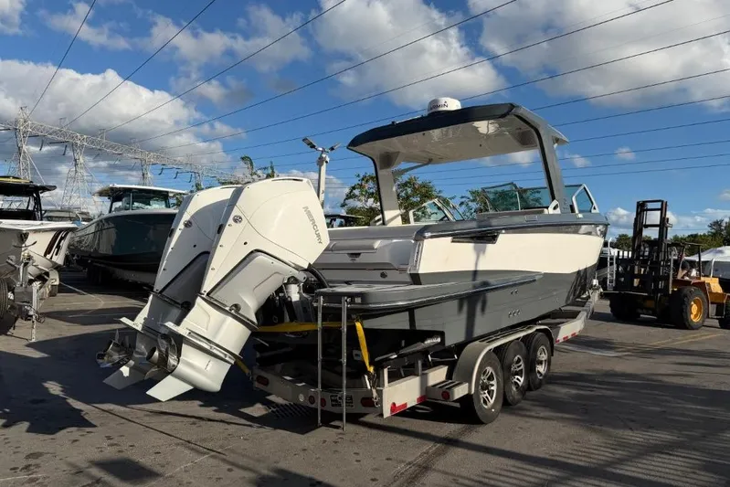  Yacht Photos Pics 2022 Aviara AV32 OB boat on trailer, outdoor display under blue sky.