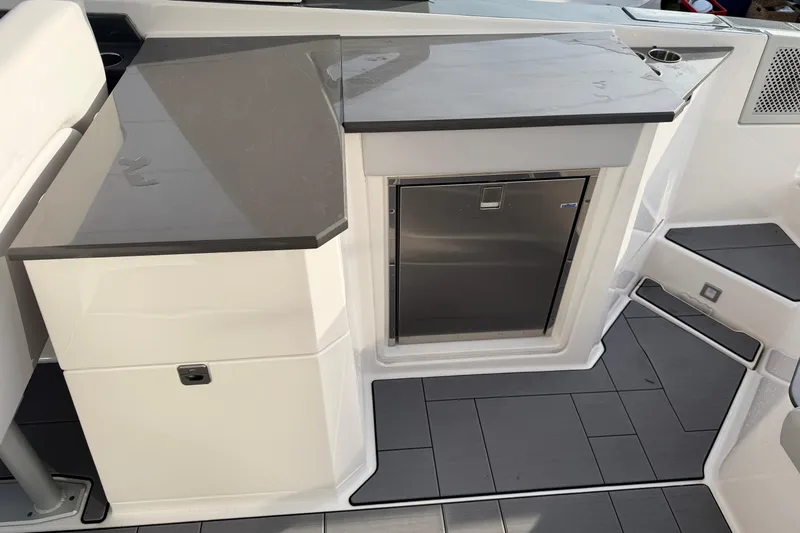  Yacht Photos Pics 2022 Aviara AV32 OB boat interior with sleek countertop and built-in stainless steel fridge.