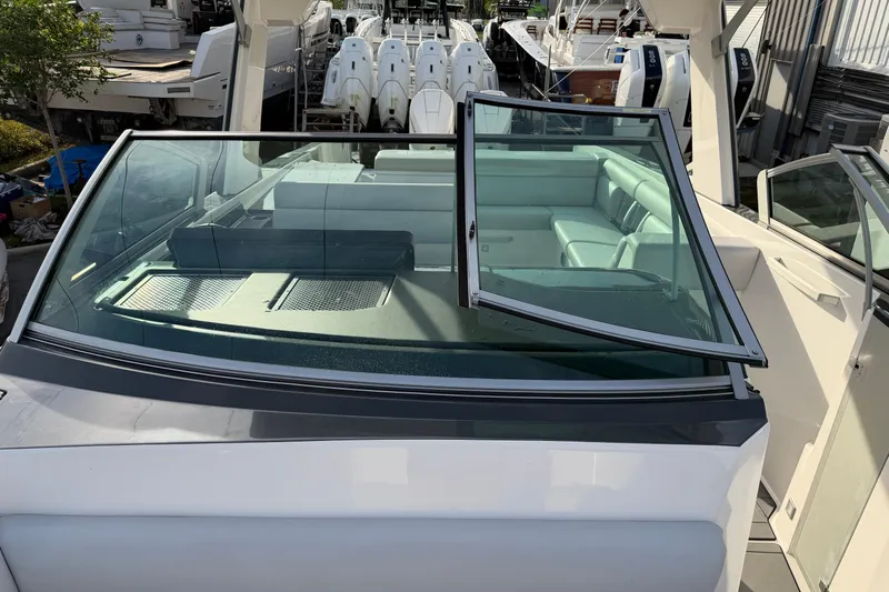  Yacht Photos Pics 2022 Aviara AV32 OB boat with open windshield and spacious seating area.