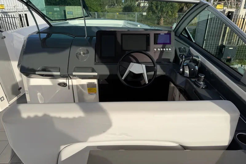  Yacht Photos Pics 2022 Aviara AV32 OB boat cockpit with modern controls and steering wheel.