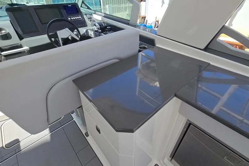  Yacht Photos Pics 2022 Aviara AV32 OB boat interior with sleek helm and modern countertop design.