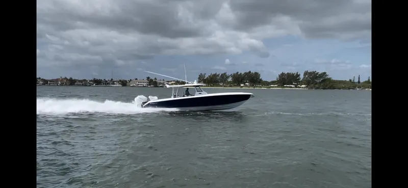 Call For Information Yacht Photos Pics 2024 Bahama 41' Open Fisherman GT cruising on water under cloudy skies.