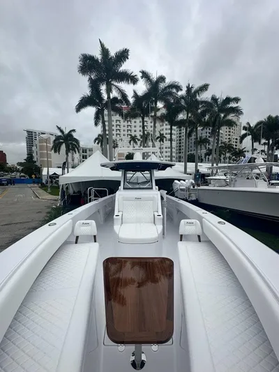 Call For Information Yacht Photos Pics 2024 Bahama 41' Open Fisherman GT boat with luxurious seating and palm trees in the background.