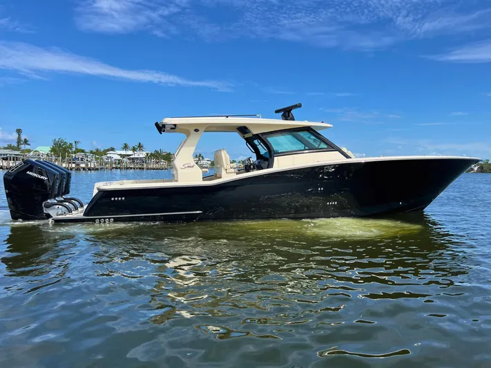  Yacht Photos Pics 2025 Scout 425 LXF boat on water, clear sky, luxury design.