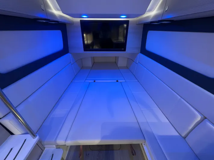 Yacht Photos Pics Luxurious interior of 2025 Scout 425 LXF boat with blue ambient lighting and TV.