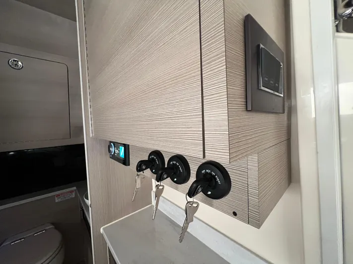  Yacht Photos Pics Interior of 2025 Scout 425 LXF boat with control panel and keys.