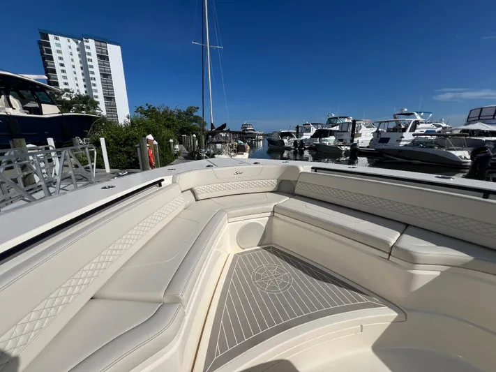  Yacht Photos Pics 2025 Scout 425 LXF boat interior with luxurious seating at a marina.
