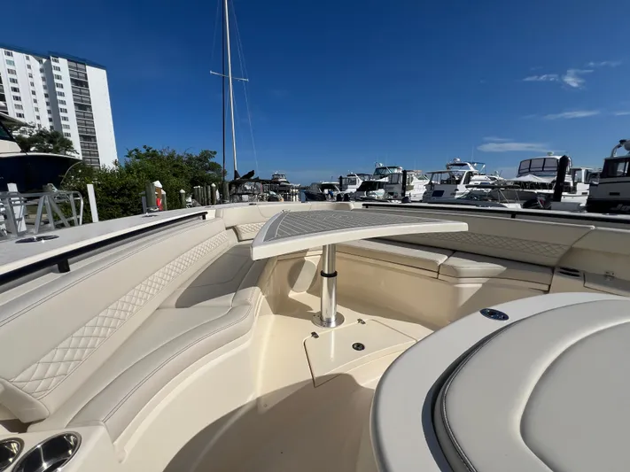  Yacht Photos Pics Luxurious 2025 Scout 425 LXF boat interior with elegant seating and table, docked at marina.