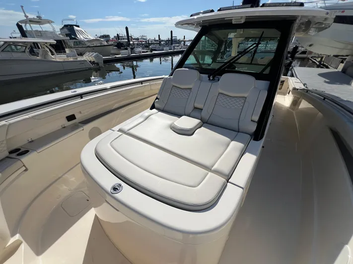  Yacht Photos Pics Luxurious 2025 Scout 425 LXF boat with plush seating at marina.