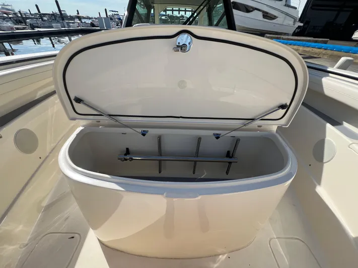  Yacht Photos Pics Open storage compartment on 2025 Scout 425 LXF boat, docked at marina.