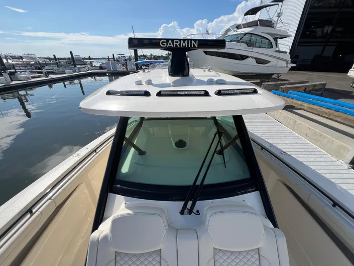  Yacht Photos Pics 2025 Scout 425 LXF boat docked, featuring Garmin equipment and sleek design.