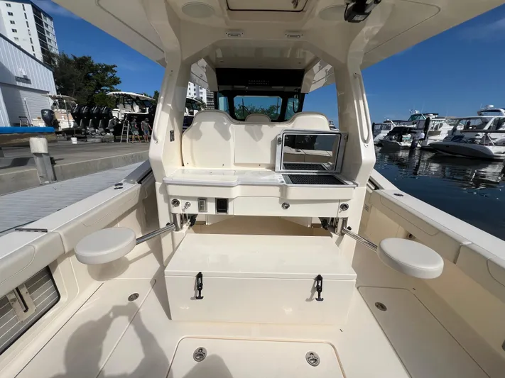  Yacht Photos Pics 2025 Scout 425 LXF boat interior with seating and grill at marina.