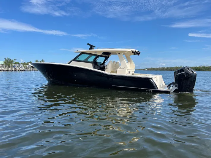  Yacht Photos Pics 2025 Scout 425 LXF boat on calm water under clear blue sky.