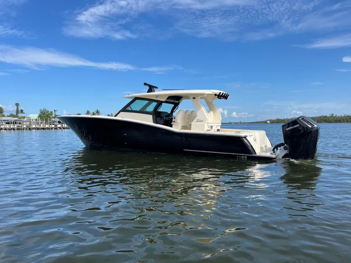  Yacht Photos Pics 2025 Scout 425 LXF boat on calm water under clear blue sky.