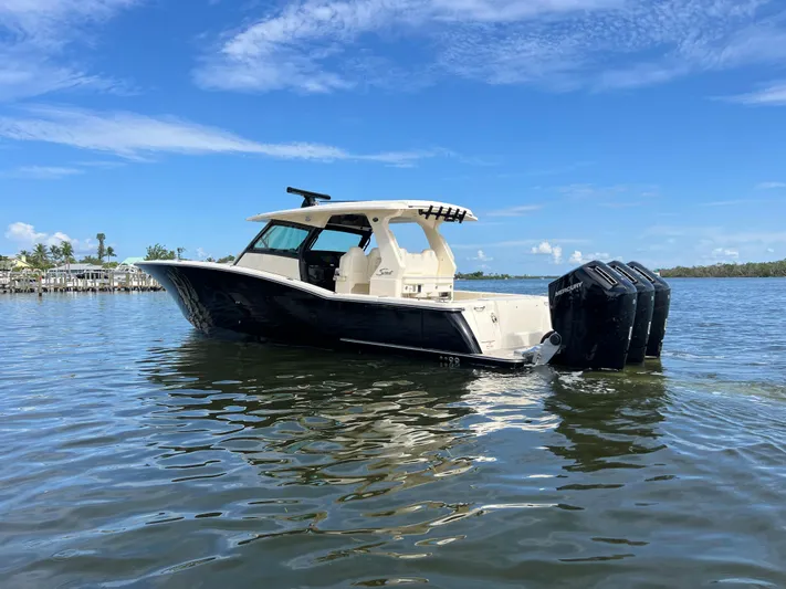  Yacht Photos Pics 2025 Scout 425 LXF boat on calm water under a clear blue sky.
