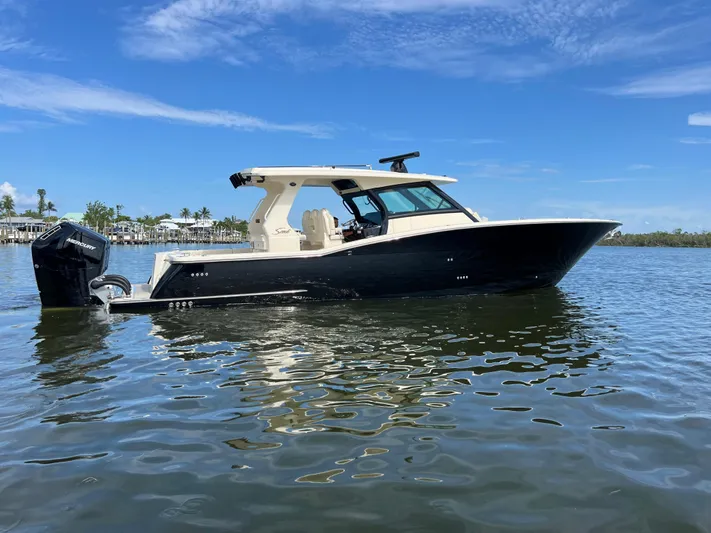  Yacht Photos Pics 2025 Scout 425 LXF boat on calm water under clear blue sky.