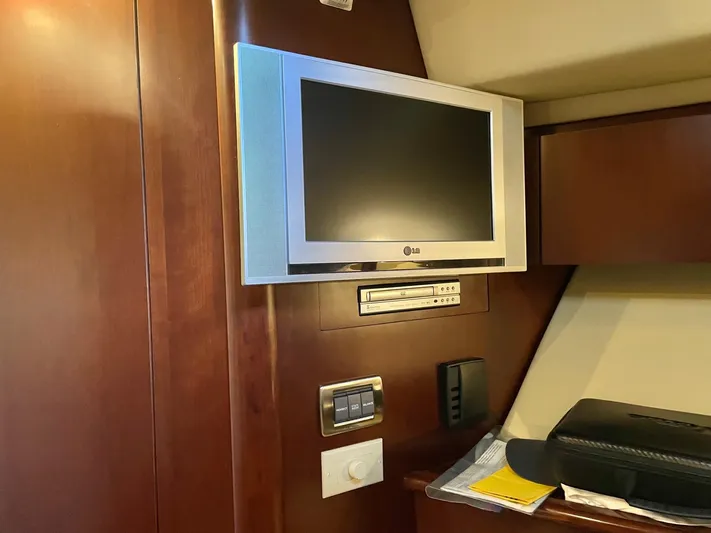 Covetime II Yacht Photos Pics Interior of 2006 Sea Ray 44 Sedan Bridge with TV and wood paneling.